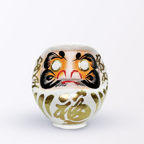 A 17-centimeter tall white Fuku-iri papier-mache daruma dolls, made by Imai Daruma Naya. All feature rotund bodies, decorative patterns for eyebrows and beards and gold body lines and kanji lettering.